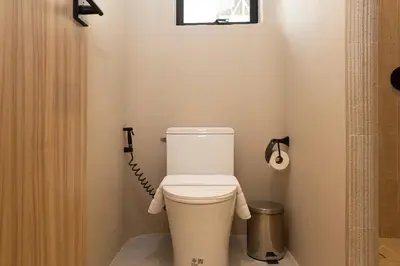 a bathroom with a toilet with a shower curtain at 2 Bedrooms 4 guests Private Floor at Sathorn in Bangkok
