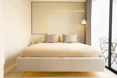 a bedroom with a bed with a large mirror above it at 2 Bedrooms 4 guests Private Floor at Sathorn in Bangkok