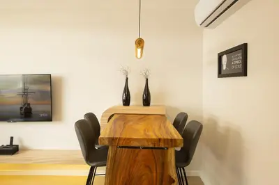 a dining room with a wooden table and chairs at 2 Bedrooms 4 guests Private Floor at Sathorn in Bangkok