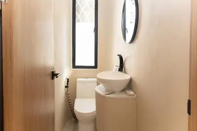 a bathroom with a toilet and a sink on top of it at 2 Bedroom for 4 Guests Private at Center Sathorn in Bangkok