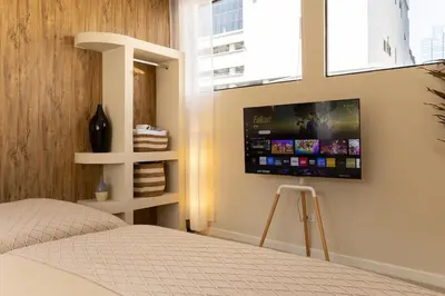 a bedroom with a flat screen tv on the wall at Studio for 3 Guests with Kitchen at Center Sathorn in Bangkok
