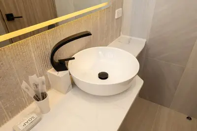 a bathroom with a sink and a toilet at Studio for 3 Guests with Kitchen at Center Sathorn in Bangkok