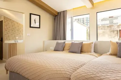 a bedroom with two beds in front of a window at Studio for 3 Guests with Kitchen at Center Sathorn in Bangkok