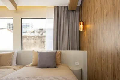 a bedroom with a bed and a large window at Studio for 3 Guests with Kitchen at Center Sathorn in Bangkok