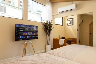 a bedroom with a bed and a tv on the wall at Studio for 3 Guests with Kitchen at Center Sathorn in Bangkok