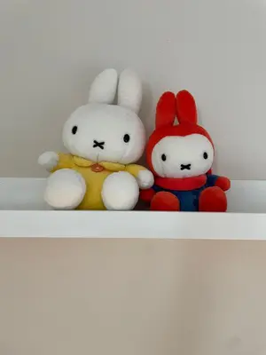 three stuffed rabbits sitting on a shelf at mug & bed in Bangkok