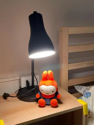 a stuffed animal sitting on a table next to a lamp at mug & bed in Bangkok