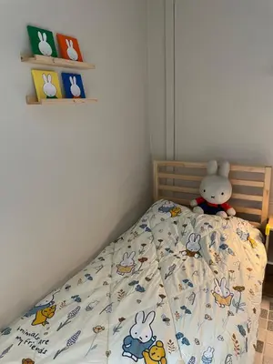 a bedroom with a bed with a stuffed animal on it at mug & bed in Bangkok