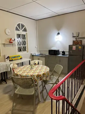 a kitchen with a table and chairs and a table and a table and a kitchen at mug & bed in Bangkok
