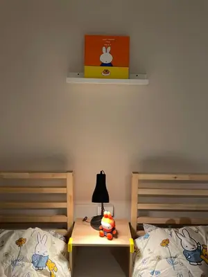 a bedroom with two beds and a table with a lamp at mug & bed in Bangkok