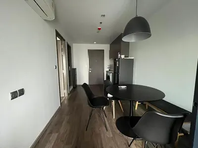 a dining room with a table and black chairs at 35sqm comfy condo near JJ Market in Bangkok