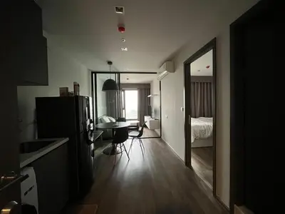 a room with a refrigerator and a table and a bed at 35sqm comfy condo near JJ Market in Bangkok