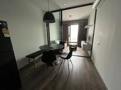 a living room with a table and chairs in a room at 35sqm comfy condo near JJ Market in Bangkok
