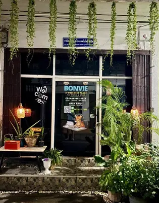 a front door of a shop with a dog on a sign in the window at Bonvie Residence in Thung Maha Mek