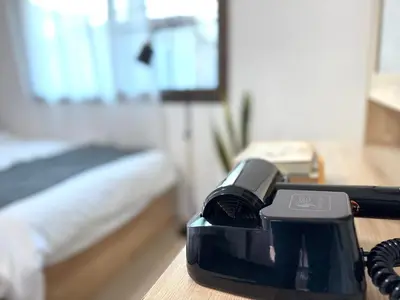 a phone sitting on a table in a room at Bonvie Residence in Thung Maha Mek