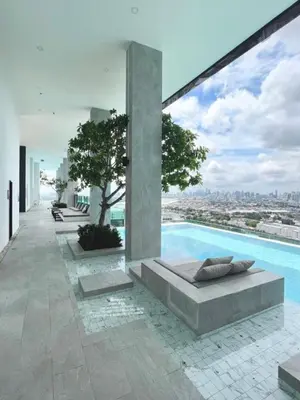 a view of a swimming pool from a house at New Luxury Condo 5 Min Onnut BTS - Modiz Sukhumvit 50 in Bangkok