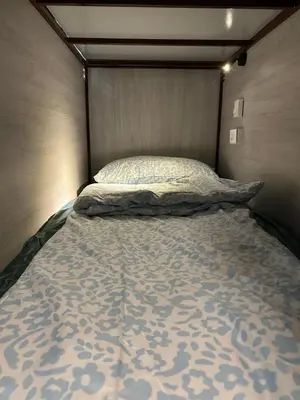 a bed in a room with a head board at Lesbase Women Hostel in Bangkok