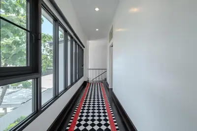 a room with a checkered floor and windows at Thong Lo Modern Pool Villa In Center Of Bangkok in Bangkok