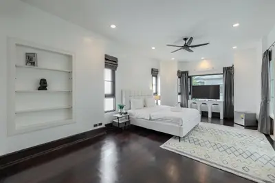 a living room with a white couch and a ceiling fan at Thong Lo Modern Pool Villa In Center Of Bangkok in Bangkok