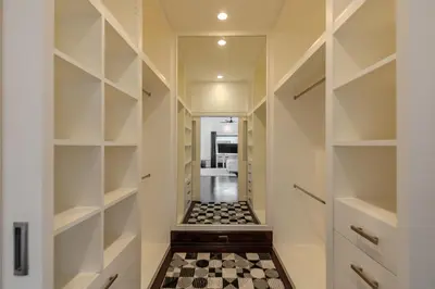a walk in closet with a checkered floor at Thong Lo Modern Pool Villa In Center Of Bangkok in Bangkok