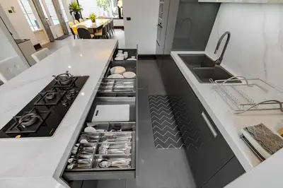 a kitchen with a stove and a sink at Thong Lo Modern Pool Villa In Center Of Bangkok in Bangkok