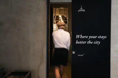 a man walking out of a door at Once Again Hostel in Bangkok