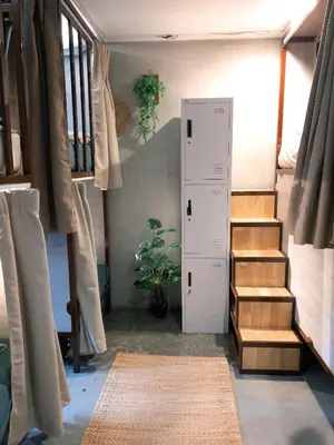 a room with a staircase and a room with a stair case at Lesbase Female 8-Bed Room in Bangkok