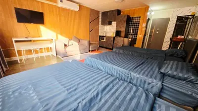 a living room with a bed and a couch at อิมแพ็ค เมืองทองธานี ห้องเช่ารายวัน เมืองทอง คอนโดเมืองทอง c9