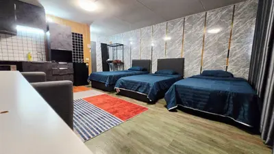a room with two beds and a television in it at อิมแพ็ค เมืองทองธานี ห้องเช่ารายวัน เมืองทอง คอนโดเมืองทอง c9