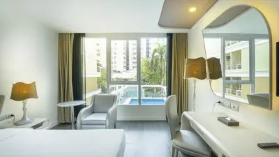 a hotel room with a view of a pool at Le Tada Parkview Hotel in Bangkok