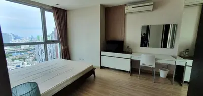 a bedroom with a bed and a desk with a mirror at Sky Walk Condo Spacious 2BR Near BTS Phra Khanong in Bangkok