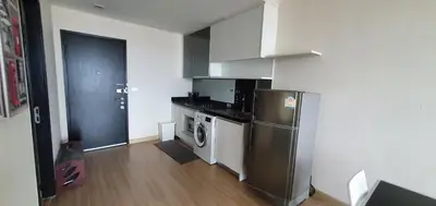 a kitchen with a refrigerator and a washing machine at Sky Walk Condo Spacious 2BR Near BTS Phra Khanong in Bangkok