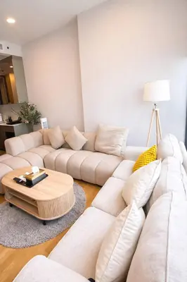 a living room with white couches and a coffee table at Luxury 1 Bedroom l BTS 2 mins l Pool and Gym in Pratunam