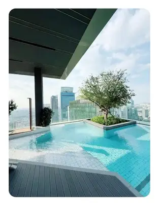 a large swimming pool on top of a building at Luxury 1 Bedroom l BTS 2 mins l Pool and Gym in Pratunam