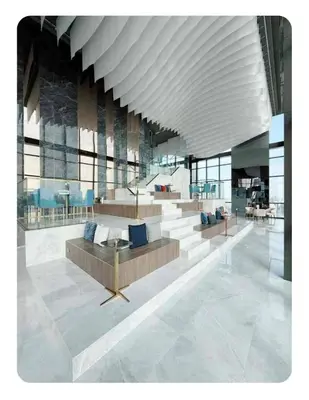 a lobby with a couch and a large ceiling at Luxury 1 Bedroom l BTS 2 mins l Pool and Gym in Pratunam