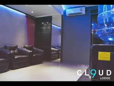 a room with two couches and a large glass vase at Cloud 9 Lodge in Bangkok