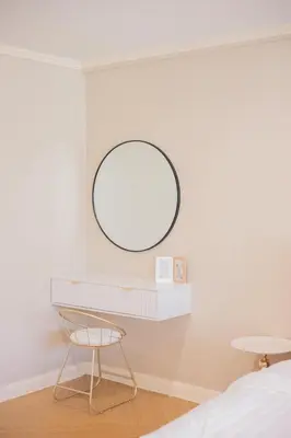 a bedroom with a mirror and a chair at Warm & Cozy Family Home, Near BTS Punnawithi in Phra Khanong