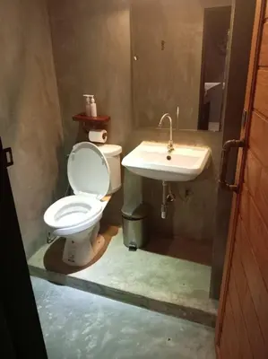 a bathroom with a toilet and a sink at Bangkok Phattanakan32 guest house in Bangkok