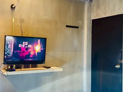 a television sitting on a shelf in a room at Bangkok Phattanakan32 guest house in Bangkok