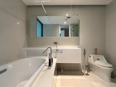a bathroom with a tub and a toilet and a mirror at City life Nana - near Bumrungrad Hospital in Bangkok