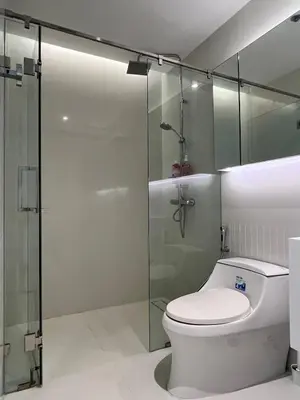 a bathroom with a toilet and a glass shower at City life Nana - near Bumrungrad Hospital in Bangkok