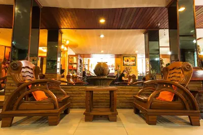 two chairs and a table in front of a restaurant at Sathorn Garden View in Bangkok