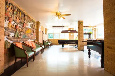 a lobby with chairs and a piano in a room at Sathorn Garden View in Bangkok
