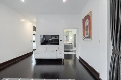 a living room with a white dresser and a mirror at Thong Lo Luxury Pool Villa In Center Of Bangkok in Bangkok