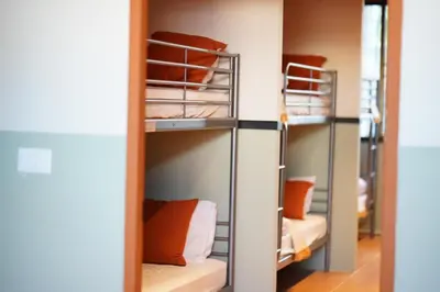 a row of bunk beds in a dorm room at Nitra Hostel Siriraj in Bangkok
