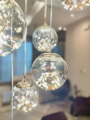 a group of glass balls hanging from a ceiling at Supreme Spacious 2-Bedroom in Prime Location! BTS Thonglor in Bangkok