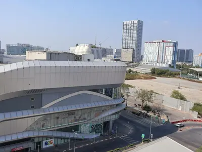 a large building with a street in front of a city at Hi Impact Muangthong T9 in Nonthaburi