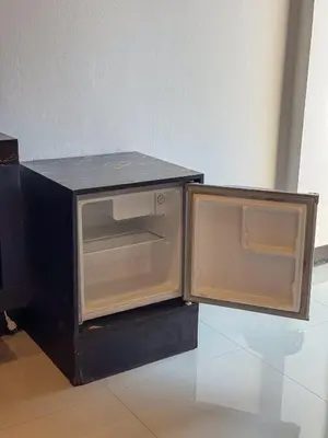 a microwave oven with its door open on a table at POR SAHA Hotel Ramkhamhaeng 100 in Bang Kapi