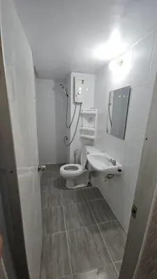 a bathroom with a toilet and a sink at CT Impact in Thung Si Kan