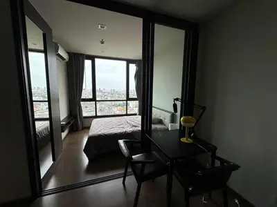 a bedroom with a bed and a desk and a window at High Rise Designer Gem Central Bangkok City View in Bangkok